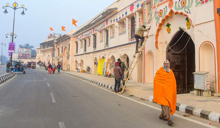 Artisans create murals to decorate buildings located along the 'Ram Path' ahead of the consecration ceremony of Ram Temple in Ayodhya | PTI