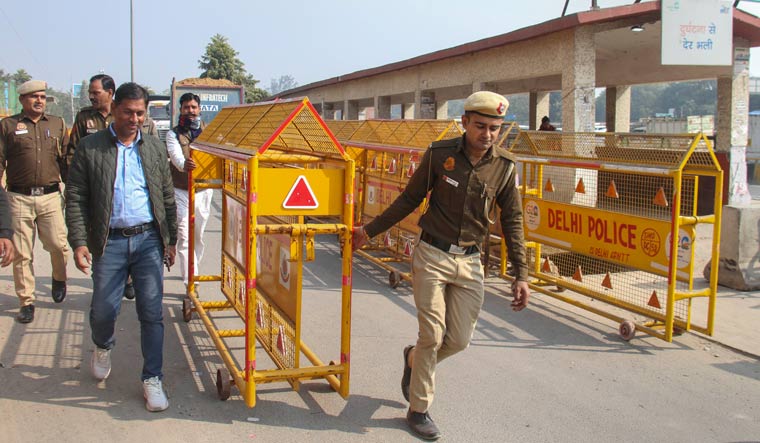 Police barricades being put up at Delhi-Gurugram border in view of farmers' 'Delhi Chalo March' | PTI
