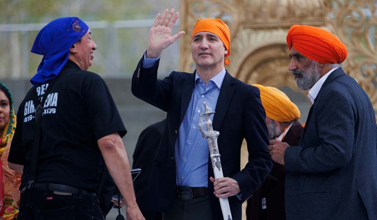 Canadian Prime Minister Justin Trudeau waves to the crowd after receiving a ceremonial talwar from the Ontario Sikhs and Gurudwara Council after speaking during Khalsa Day celebrations at City Hall in Toronto | AP