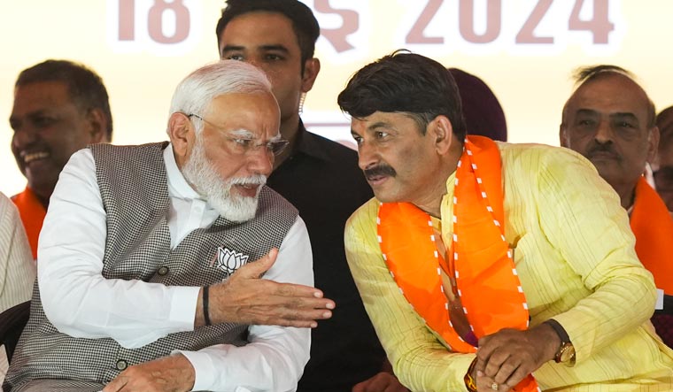 Prime Minister Narendra Modi with Manoj Tiwari during a rally at Kartar Nagar in Delhi | PTI