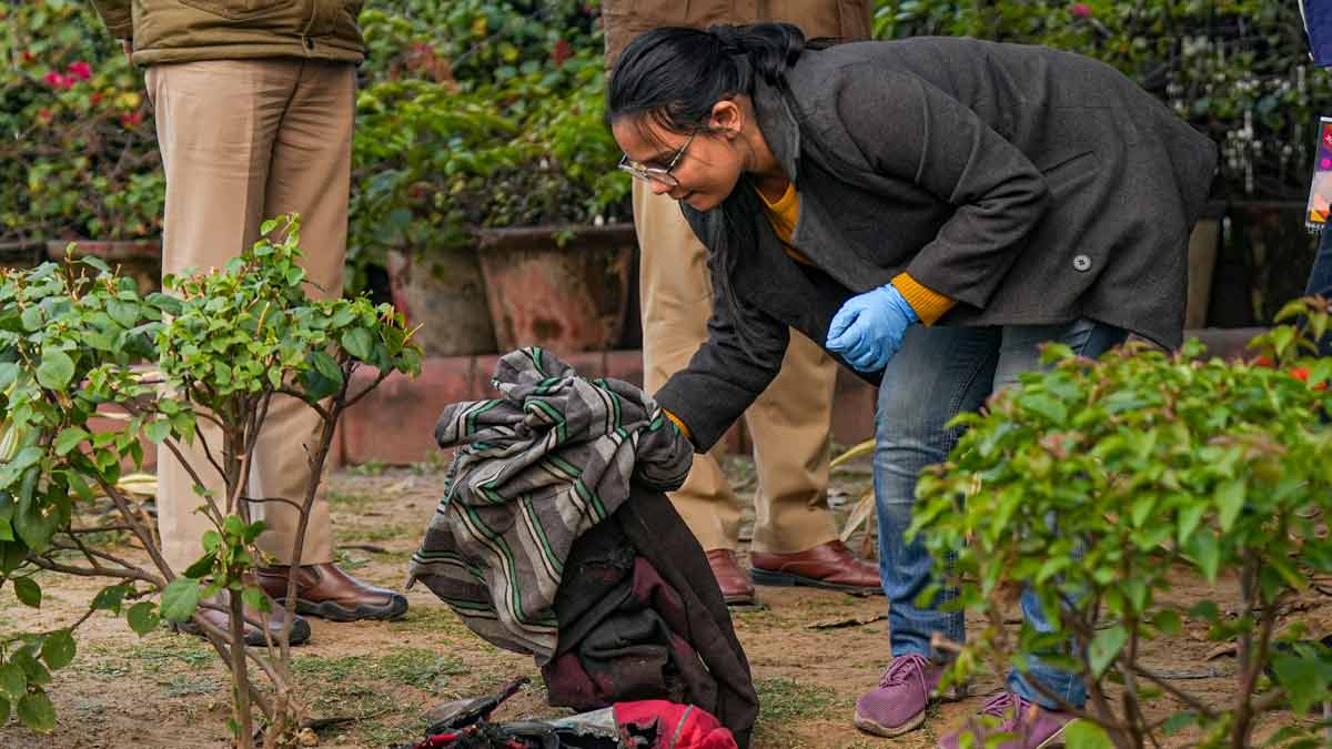 A member of the forensic team of Delhi Police Crime Branch conducts investigation at the spot where a man tried to immolate himself near the Railway Bhawan opposite the new Parliament building | PTI