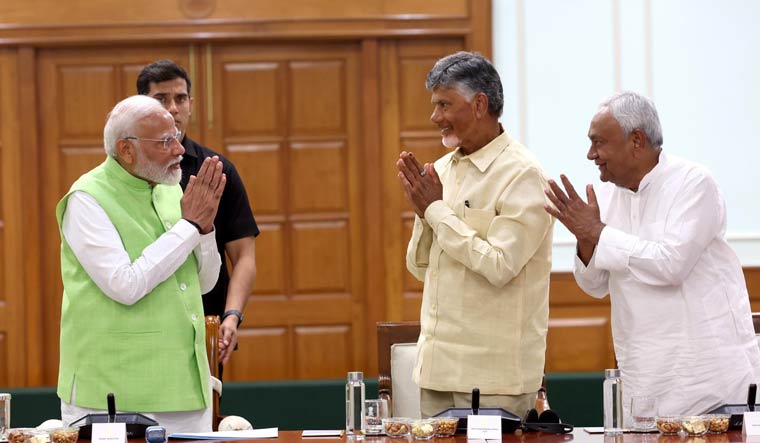 Prime Minister Narendra Modi greets TDP president Chandrababu Naidu and Bihar Chief Minister Nitsih Kumar | X