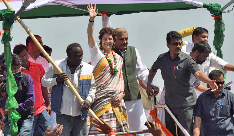 Congress general secretary Priyanka Gandhi Vadra waves to her party supporters at Assi Ghat, in Varanasi | PTI