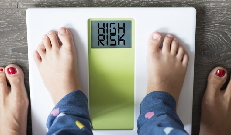 Childhood-kid-child-obesity-high-risk-health-weight-scale-mother-shut