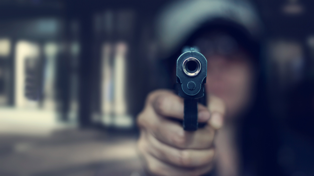 Woman-pointing-gun-front-murder-gunshot-shut