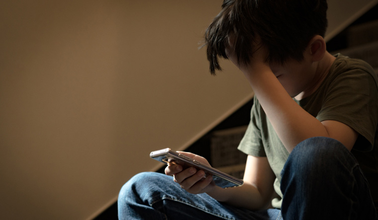 cyber-bullied-boy-smartphone-cyber-bullying-Alone-stressed-frustrated-depression-shut