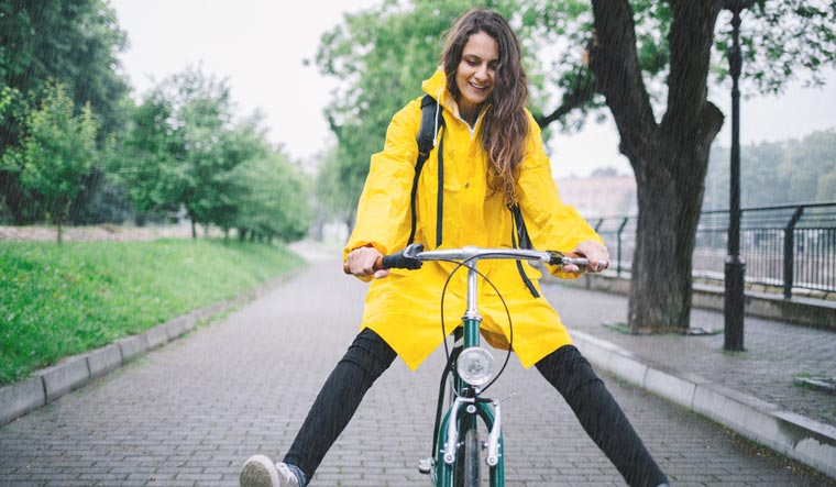 cycling-woman-yellow-coat-cycle-shut