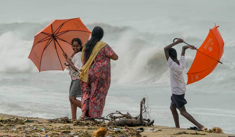 Locals visit the Marina Beach as high tidal waves lash the shore owing to Cyclone Michaung, in Chennai | PTI