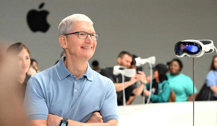 Apple CEO Tim Cook speaks with members of the media next to Apple's new Vision Pro virtual reality headset, during Apple’s Worldwide Developers Conference (WWDC) at the Apple Park campus in Cupertino, California | AFP