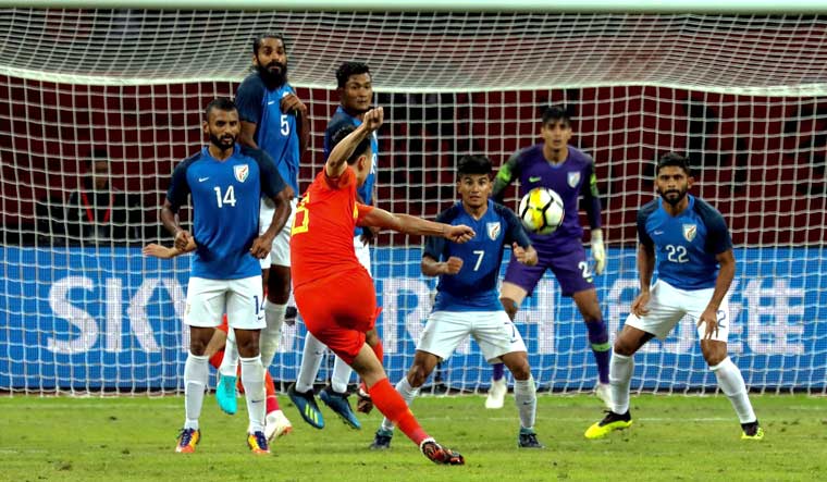 China's Gao Lin (centre) takes a shot at goal during an international friendly football match against India in Suzhou | AFP