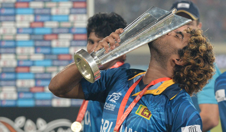 (File) Sri Lanka captain Lasith Malinga kisses the ICC World Twenty20 trophy after defeating India at the Sher-e-Bangla National Cricket Stadium in Dhaka in 2014 | AFP