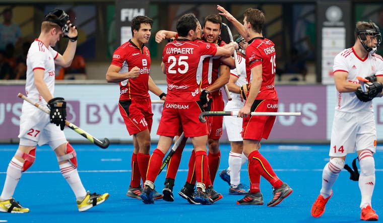 Belgium's Simon Gougnard (centre) is hugged by his teammates after scoring a goal during the men's Hockey World Cup semifinal against England at the Kalinga Stadium in Bhubaneswar | AP