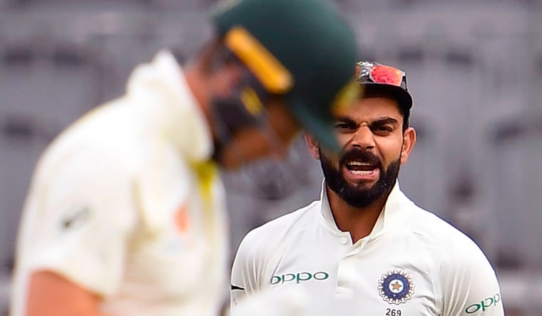 India captain Virat Kohli (right) is seen yelling at Australia captain Tim Paine on the third day of the Perth Test | AFP
