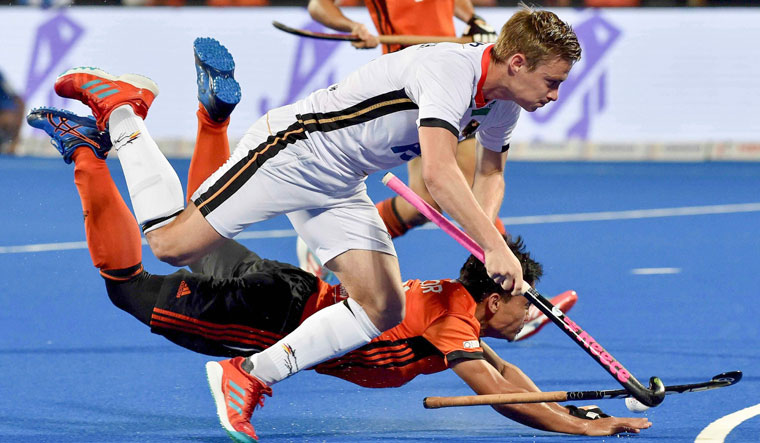 Germany's Mats Grambusch (in white) and Malaysia's Azuan Hasan vie for the ball during their match, at Men's Hockey World Cup 2018, in Bhubaneswar, on Sunday | PTI