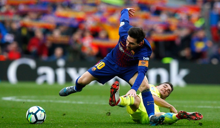 FC Barcelona's Lionel Messi (left) vies for the ball with Getafe's Mauro Arambarri during their La Liga match | AP