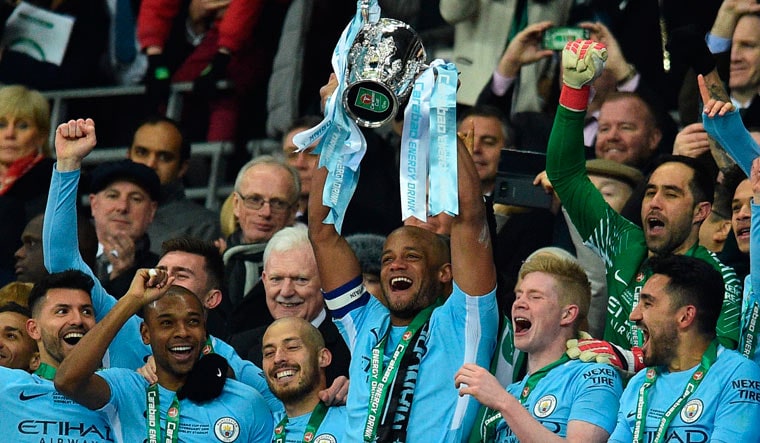 Manchester City players celebrate their victory in the English League Cup final against Arsenal at Wembley stadium | AFP