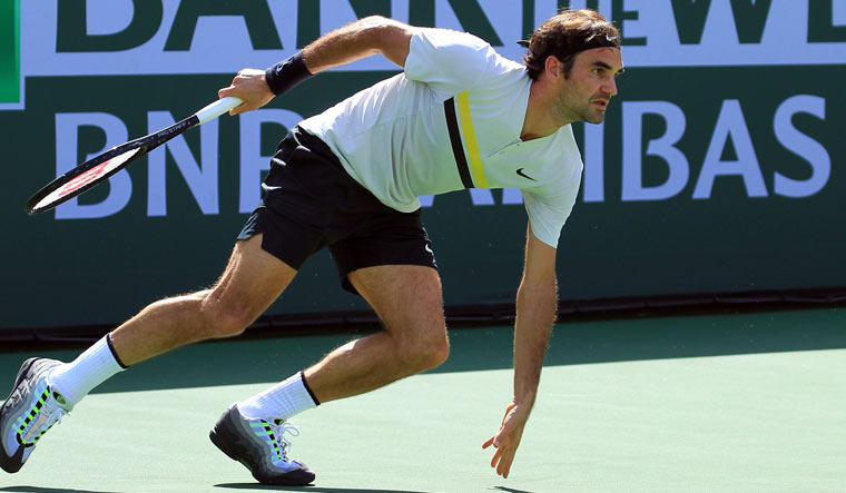 Roger Federer pivots to chase down a shot from Filip Krajinovic | AP