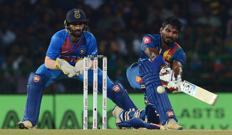Sri Lanka's cricketer Kusal Perera (R) plays a shot | AFP