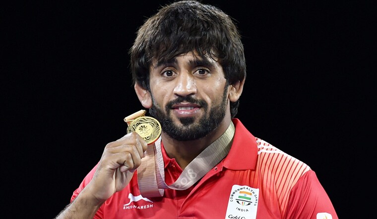Bajrang Punia poses with his gold medal after winning the 65kg freestyle category in wrestling | PTI