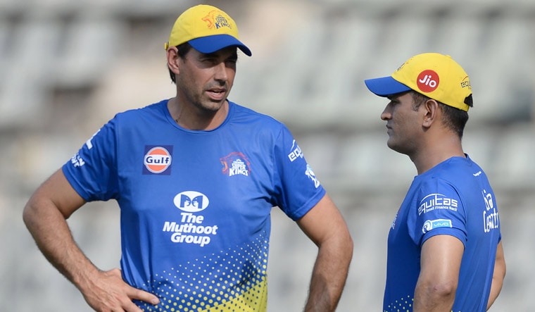 Chennai Super Kings captain Mahendra Singh Dhoni (R) speaks with coach Stephen Fleming during the training session at the Wankhede Stadium in Mumbai | AFP