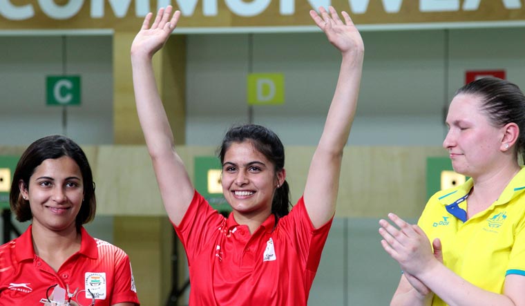 Manu Bhaker reacts after winning the gold medal with Sidhu Heena (left) and Australia's Elena Galiabovitch | AP