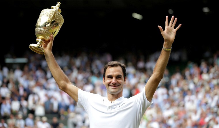 (File) Roger Federer poses with the trophy as he celebrates winning the 2017 Wimbledon final against Croatia’s Marin Cilic | Reuters