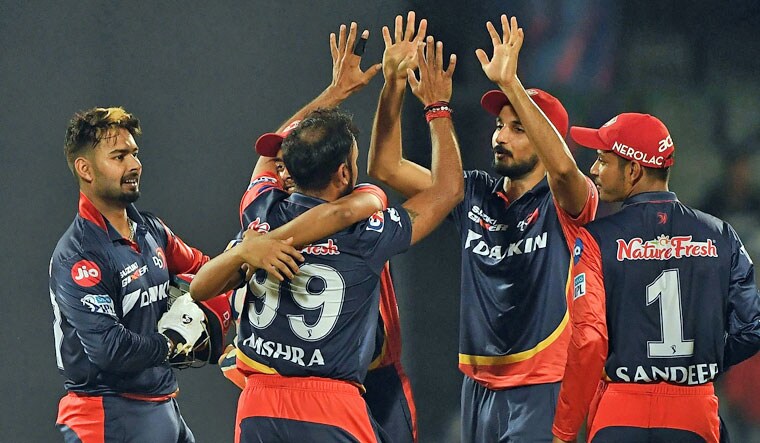 Delhi Daredevils cricketer Amit Mishra (#99) celebrates the wicket of Mumbai Indians cricketer Hardik Pandya with teammates during the 2018 Indian Premier League (IPL) Twenty20 cricket match between Delhi Daredevils and Mumbai Indians at the Feroz Shah Kotla cricket stadium in New Delhi on May 20, 2018 | AFP