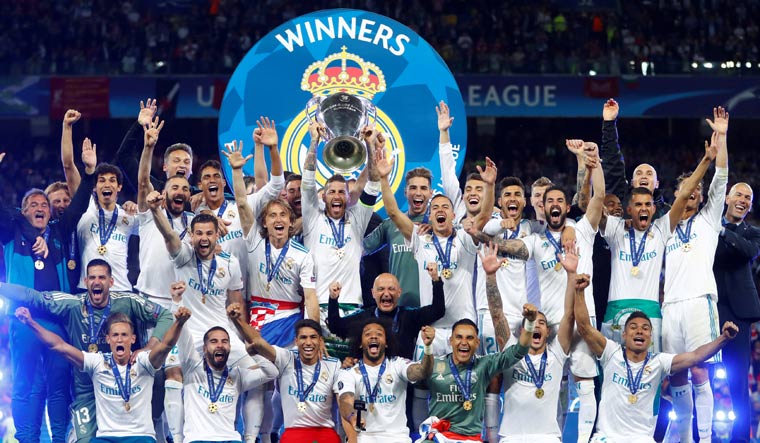 Real Madrid celebrate winning the Champions League with the trophy | Reuters