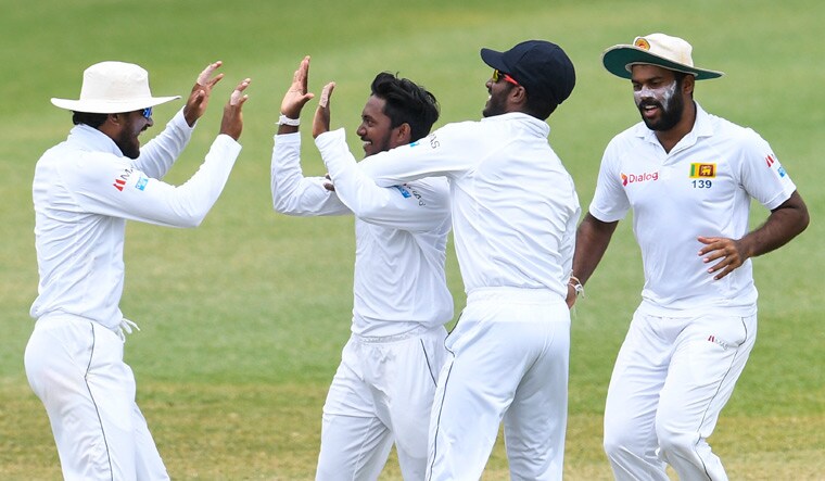 Sri Lanka's Akila Dananjaya (second from left) celebrates with teammates on the dismissal of West Indies' Shane Dowrich on day 5 | AFP
