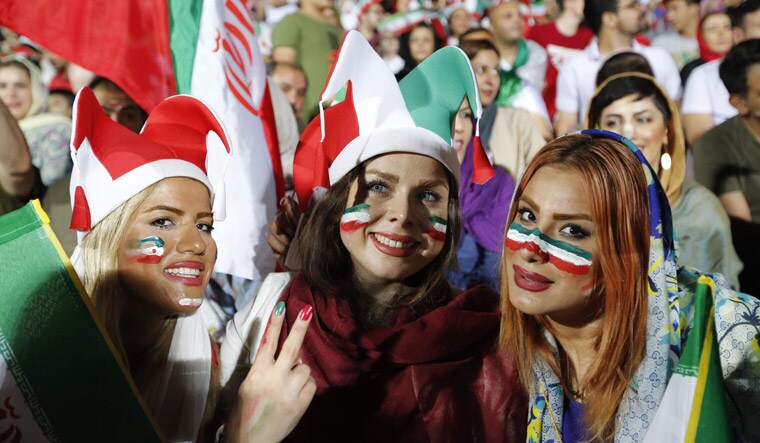 Iranian women watch the World Cup group match between Portugal and Iran at Azadi stadium in Tehran | AFP