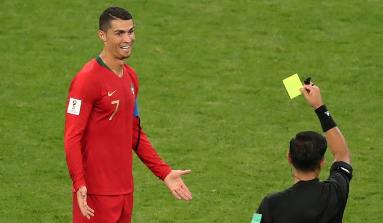 Portugal's Cristiano Ronaldo is shown a yellow card by referee Enrique Caceres | Reuters