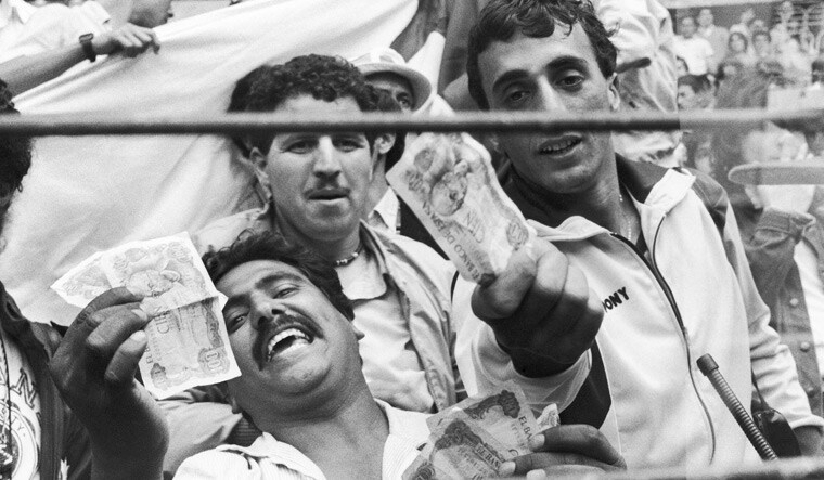 Algerian fans show money during the infamous match between West Germany and Austria in the 1982 World Cup | AP
