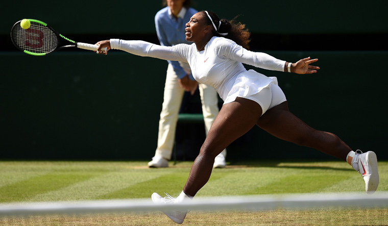 Serena Williams returns against Italy's Camila Giorgi during their women's singles quarter-final match | AFP