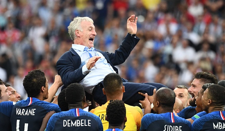 France's coach Didier Deschamps and players celebrate after winning the World Cup final | AFP