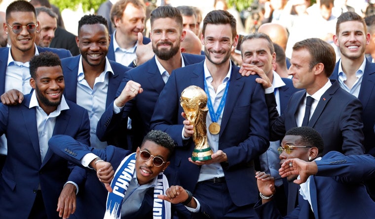 France's players celebrate with President Emmanuel Macron at the Elysee Palace in Paris | Reuters