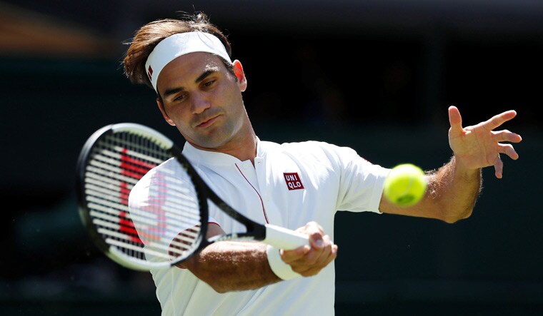 Roger Federer in action during the first round match against Serbia's Dusan Lajovic at the Wimbledon | Reuters