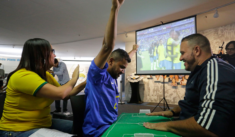 Brazil fan who is deaf, blind follows World Cup with help