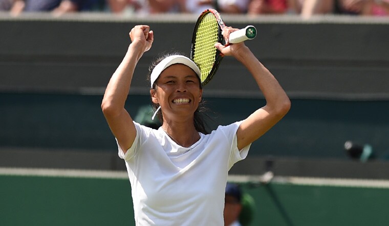Taiwan's Hsieh Su-Wei celebrates after beating Romania's Simona Halep 3-6, 6-4, 7-5 in their women's singles third round match at the 2018 Wimbledon Championships | AFP