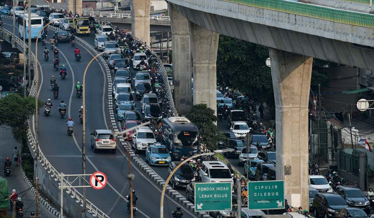 Vehicles crawl through gridlocked traffic during morning rush hour in Jakarta | AFP