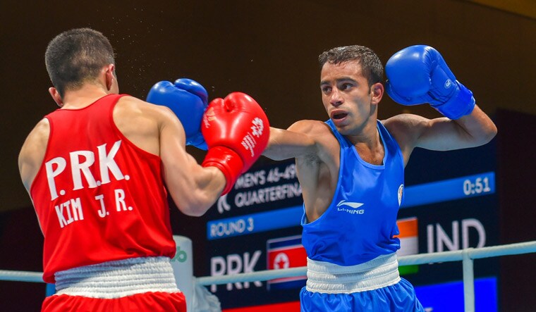 India's Amit Panghal (right) and PR Korea's Ryong Jong compete in the men's light fly (46-49kg) quarterfinal | PTI