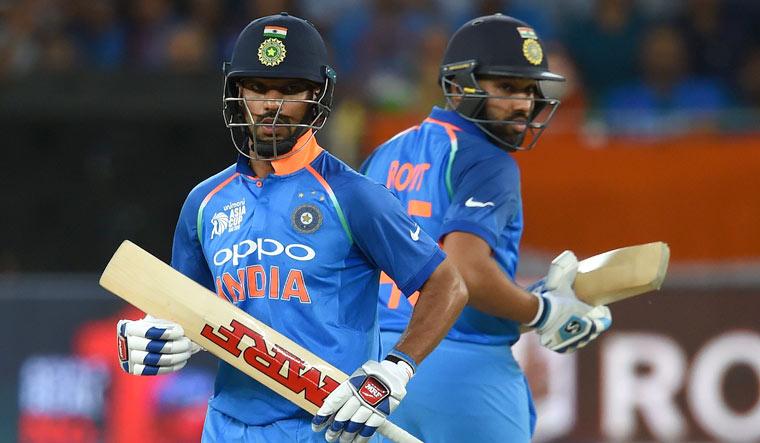 Indian captain Rohit Sharma (right) and Shikhar Dhawan runs between the wickets during the Asia Cup ODI match at the Dubai International Cricket Stadium | AFP