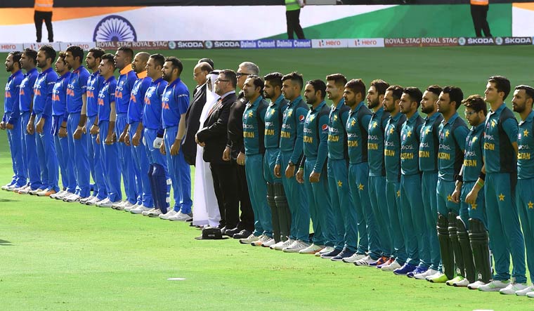 Indian and Pakistani players line up for the national anthem just before the start of the ODI match during the Asia Cup at the Dubai International Cricket Stadium | AFP