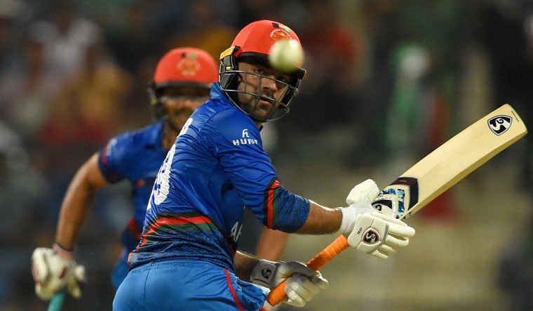 Afghanistan batsman Rashid Khan (right) plays a shot during the Asia Cup match against Bangladesh at the Sheikh Zayed Stadium in Abu Dhabi | AFP