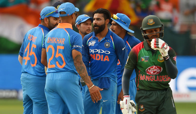 Ravindra Jadeja (centre) celebrates with teammates after he dismissed Bangladesh batsman Mohammad Mithun (right) during the Asia Cup match at the Dubai International Cricket Stadium | AFP