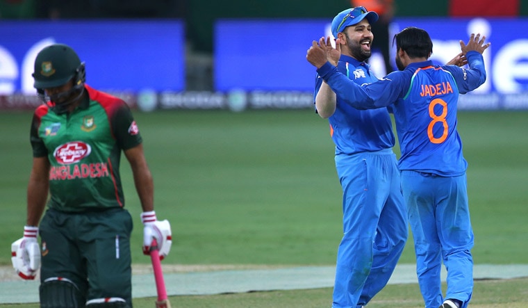 Ravindra Jadeja [right] celebrates with captain Rohit Sharma the dismissal of Bangladesh's Mosaddek Hossain, during the one day international cricket match of Asia Cup between India and Bangladesh in Dubai | AP