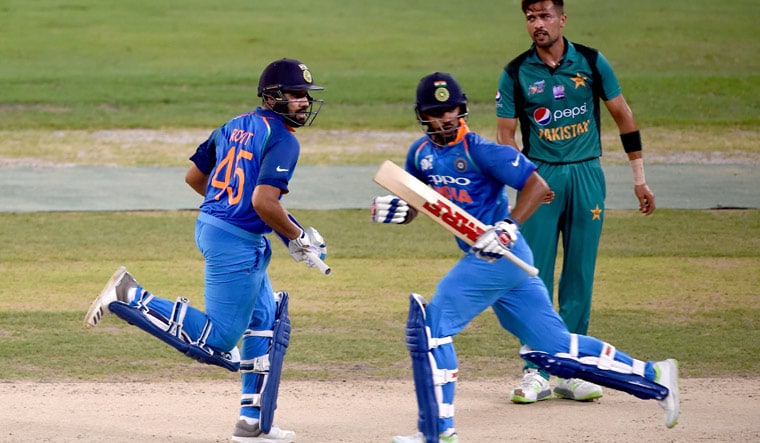 Rohit Sharma [left] and his teammate Shikhar Dhawan run between the wickets during the one day international (ODI) Asia Cup cricket match between Pakistan and India at the Dubai International Cricket Stadium in Dubai  | AFP