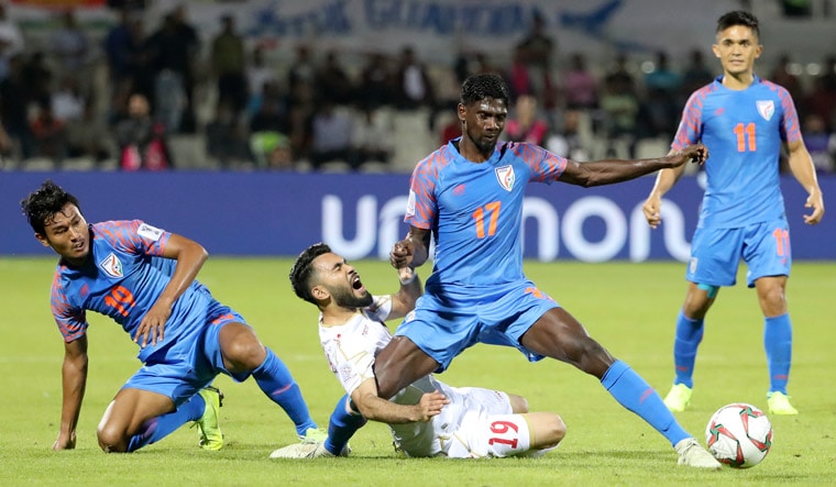 Bahrain's midfielder Kamil Al Aswad (second from left) fights for the ball with India's midfielder Rowllin Borges | AFP