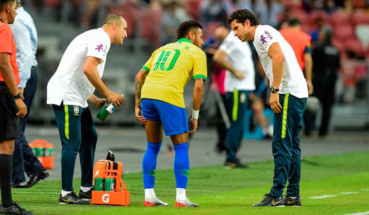 Brazil forward Neymar (centre) leaves the field during an international friendly match against Nigeria at the National Stadium in Singapore | AFP