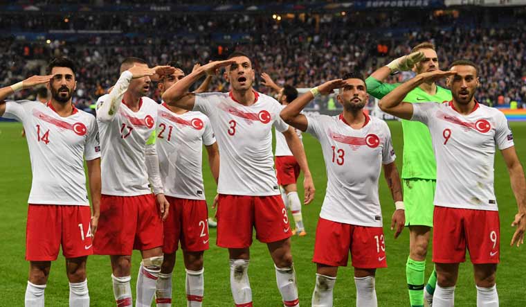 Turkish players salute at the end of the Euro 2020 Group H qualification football match between France and Turkey at the Stade de France in Saint-Denis, outside Paris | AFP