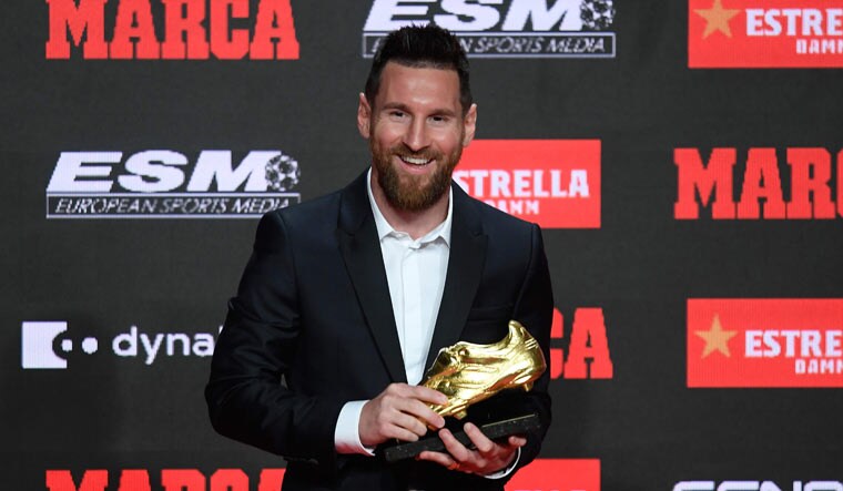 Barcelona's Argentinian forward Lionel Messi poses with his sixth Golden Shoe trophy during a ceremony at the Antigua Fabrica Estrella Damm in Barcelona | AFP